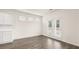 Open living space with gray hardwood floors, white walls and access to the backyard at 291 Sandy Oak Dr, Loganville, GA 30052