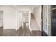 Bright living room featuring hardwood floors, a staircase, and an open doorway to other rooms at 291 Sandy Oak Dr, Loganville, GA 30052