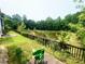 Backyard view featuring lush greenery, a tranquil pond, and a deck at 1560 Park Grove Dr, Lawrenceville, GA 30046