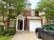 Charming two-story brick home with a covered entryway and attached single car garage at 1560 Park Grove Dr, Lawrenceville, GA 30046