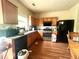 Kitchen with wood cabinets, stainless steel appliances, and a wood plank floor at 1560 Park Grove Dr, Lawrenceville, GA 30046