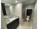 Bathroom features a vanity with granite countertops, a large mirror, and tile floors at 3117 Colonial Way # G, Atlanta, GA 30341