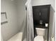 Bathroom features a shower/tub combo, toilet, and black shelving cabinet at 3117 Colonial Way # G, Atlanta, GA 30341