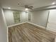 This bedroom features a ceiling fan, two windows, and light-colored walls and flooring at 3117 Colonial Way # G, Atlanta, GA 30341