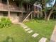A beautifully landscaped building featuring a stone walkway, green lawn, and mature trees at 3117 Colonial Way # G, Atlanta, GA 30341