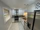 Bright and modern kitchen with stainless steel appliances, granite countertops, and ample cabinet space at 3117 Colonial Way # G, Atlanta, GA 30341
