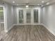 Bright living room featuring hardwood floors, fresh paint, and access to a private outdoor space at 3117 Colonial Way # G, Atlanta, GA 30341