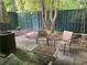 Relaxing patio area with seating, an umbrella, and a lush green privacy fence at 3117 Colonial Way # G, Atlanta, GA 30341