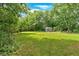Green backyard with a storage shed, perfect for enjoying outdoor living at 104 Gilreath Rd, Cartersville, GA 30121
