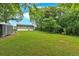 Wide shot of the backyard with green grass, a shed, and the house in the background at 104 Gilreath Rd, Cartersville, GA 30121
