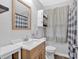 Clean bathroom with a light wood vanity, mirror, and a shower/tub combination at 104 Gilreath Rd, Cartersville, GA 30121
