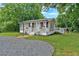 Lovely single-story home with neutral siding, white trim, and a welcoming front porch with flower boxes at 104 Gilreath Rd, Cartersville, GA 30121
