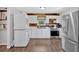 Bright kitchen features stainless steel appliances, white cabinets, and a stacked washer/dryer set at 104 Gilreath Rd, Cartersville, GA 30121