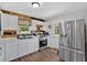 Bright kitchen features stainless steel appliances and white cabinets with a view to the backyard at 104 Gilreath Rd, Cartersville, GA 30121