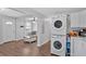 A shot of the living room with natural light, hardwood floors, and stacked washer/dryer set near the entryway at 104 Gilreath Rd, Cartersville, GA 30121
