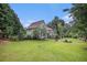 Expansive backyard with lush green lawn and mature trees offers a private retreat at 270 Meadow View Dr, Grayson, GA 30017