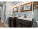 Bathroom with double sink vanity with modern faucets and framed mirrors with decorative lighting at 270 Meadow View Dr, Grayson, GA 30017