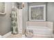 Bathroom featuring a tub and shower, vanity, and bright natural light at 270 Meadow View Dr, Grayson, GA 30017