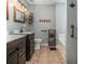 Bathroom features a double sink with vanity, tiled floors, soaking tub, and elegant decor at 270 Meadow View Dr, Grayson, GA 30017