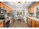 Modern kitchen with stainless steel appliances, wooden cabinets, and an island view to breakfast room at 270 Meadow View Dr, Grayson, GA 30017