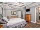 Inviting main bedroom with tray ceilings, a four-poster bed, and a private en-suite bathroom at 270 Meadow View Dr, Grayson, GA 30017