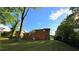 Brick home with trees and a grassy backyard at 2390 Tiffany Pl, Decatur, GA 30035