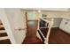 Staircase down to the basement featuring dark hardwood floors and white railings at 2390 Tiffany Pl, Decatur, GA 30035