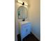 Charming bathroom featuring a modern vanity, sleek black faucet, and arched mirror at 2390 Tiffany Pl, Decatur, GA 30035