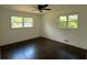 Bright bedroom features wood floors, fresh paint, new ceiling fan, and large windows at 2390 Tiffany Pl, Decatur, GA 30035