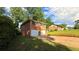 Brick home with two-car garage features mature trees and a spacious front yard at 2390 Tiffany Pl, Decatur, GA 30035