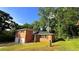 Charming home featuring red brick exterior, green lawn, and a driveway leading to a two-car garage at 2390 Tiffany Pl, Decatur, GA 30035