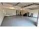 Large two-car garage features tall ceilings, painted floors, and extra space for storage at 2390 Tiffany Pl, Decatur, GA 30035