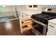 A full view of a gas oven with cabinet storage to the left at 2390 Tiffany Pl, Decatur, GA 30035