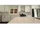 A close up of a kitchen features stainless steel appliances and crisp white cabinets at 2390 Tiffany Pl, Decatur, GA 30035