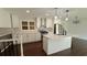 Modern kitchen features an island, stainless steel appliances, and white cabinetry and dark wood floors at 2390 Tiffany Pl, Decatur, GA 30035
