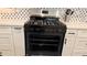 A Frigidaire gas range oven with black grates sits amid the all-white kitchen cabinetry at 2390 Tiffany Pl, Decatur, GA 30035