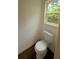 A cozy powder room features a commode and window at 2390 Tiffany Pl, Decatur, GA 30035