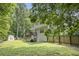 Backyard view featuring a shed, deck, and fencing surrounding the yard at 263 Chandler Ridge Dr, Douglasville, GA 30134