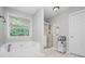 Bright bathroom with a soaking tub, walk-in shower, and natural light from the window at 263 Chandler Ridge Dr, Douglasville, GA 30134