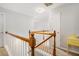 Bright hallway with wood and white railing leading to bedrooms and other living spaces at 263 Chandler Ridge Dr, Douglasville, GA 30134