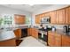 Functional kitchen with light wood cabinets, stainless steel appliances, and neutral countertops at 263 Chandler Ridge Dr, Douglasville, GA 30134
