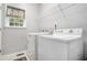 Dedicated laundry room with white washer and dryer units and shelving for storage at 263 Chandler Ridge Dr, Douglasville, GA 30134
