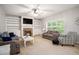 Comfortable living room featuring a stone fireplace, built-in shelving, and lots of natural light at 263 Chandler Ridge Dr, Douglasville, GA 30134