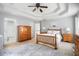 Spacious main bedroom featuring tray ceilings, neutral paint, and a connecting bathroom at 263 Chandler Ridge Dr, Douglasville, GA 30134