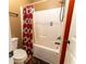 Clean bathroom with tub and shower featuring a patterned curtain at 366 Highbranch Cir, Lawrenceville, GA 30044