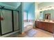 Bright bathroom featuring a shower with glass door, soaking tub and double vanity with ample counter space at 366 Highbranch Cir, Lawrenceville, GA 30044