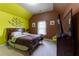 Cozy bedroom featuring neutral carpet, large window, and uniquely painted walls at 366 Highbranch Cir, Lawrenceville, GA 30044