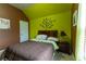 Comfortable bedroom with neutral carpet, large window, and uniquely painted walls at 366 Highbranch Cir, Lawrenceville, GA 30044