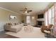 Cozy living room with a fireplace, plush sofa, and large windows; ideal for relaxation and entertainment at 366 Highbranch Cir, Lawrenceville, GA 30044