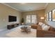 Relaxing living room featuring a comfortable sectional, large TV, and natural light; perfect for unwinding at 366 Highbranch Cir, Lawrenceville, GA 30044
